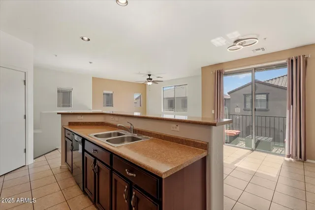 a kitchen that has a sink and a stove in it