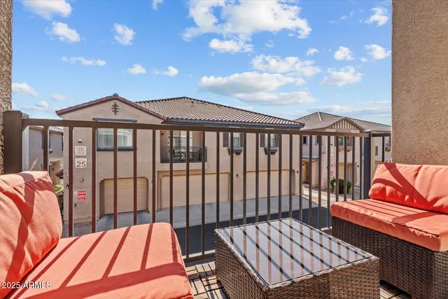 a view of a roof deck with wooden chairs
