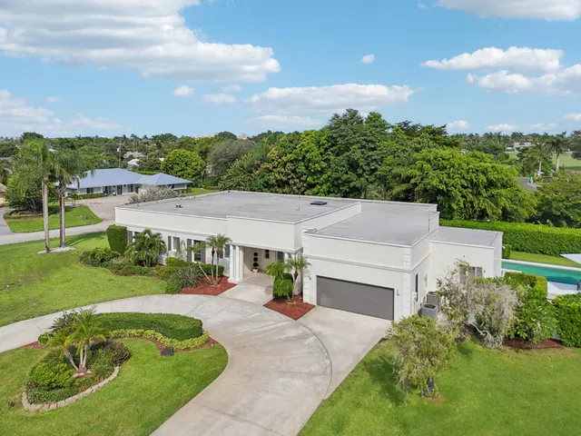 an aerial view of a house with garden space and street view