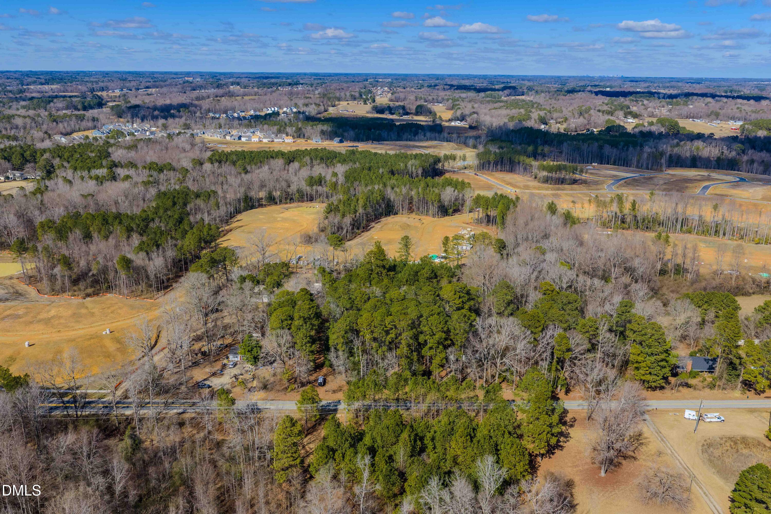6724 Wimberly Road Willow Spring, NC 27592 - Photo 18 of 36 a view of a lake with a city