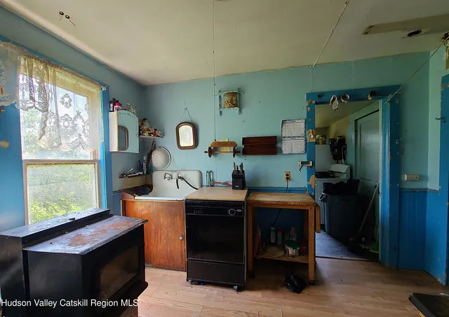 a room with furniture a large window and wood floor