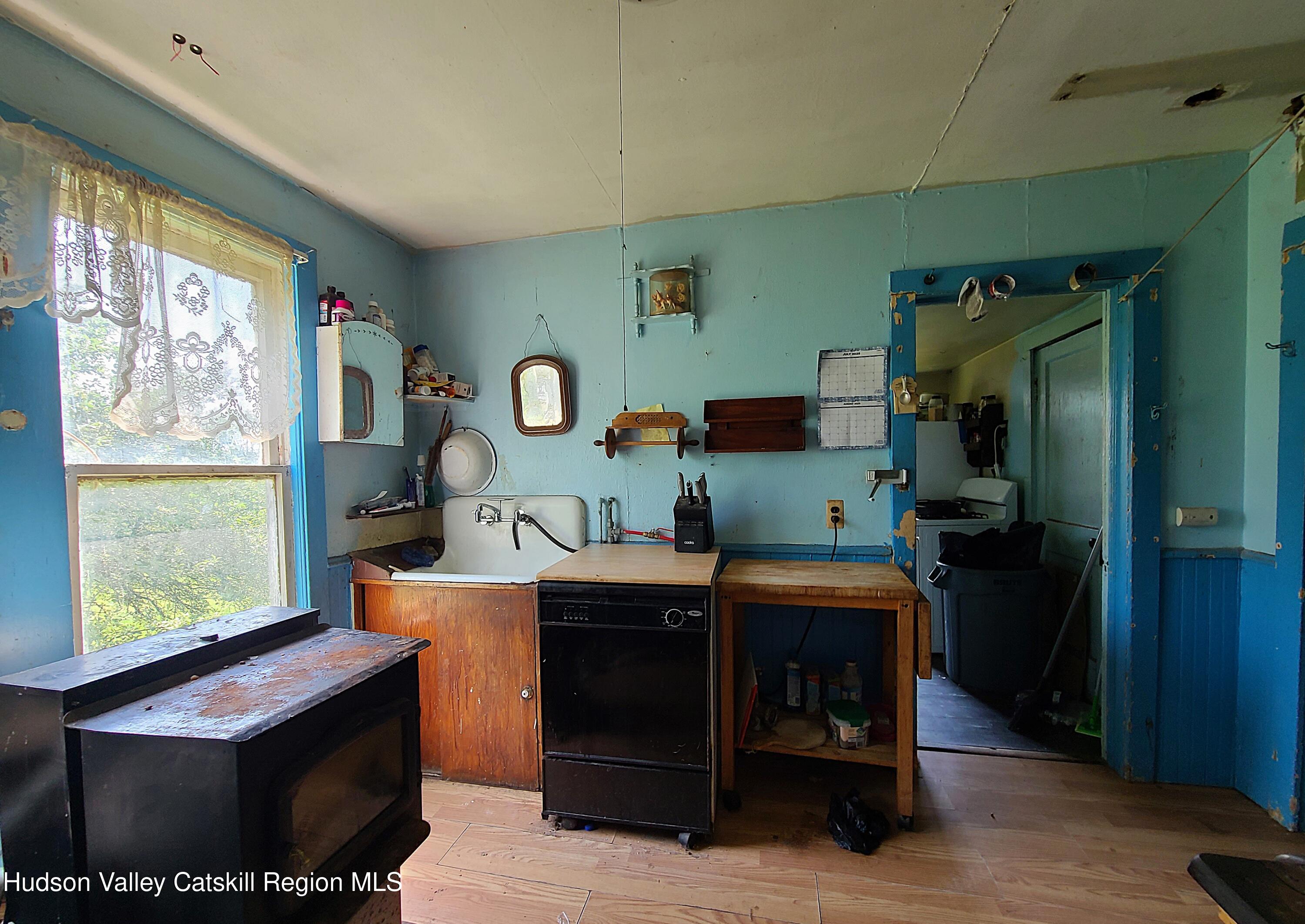 301 Stump Pond Road Livingston Manor, NY 12758 - Photo 24 of 49 a room with furniture a large window and wood floor