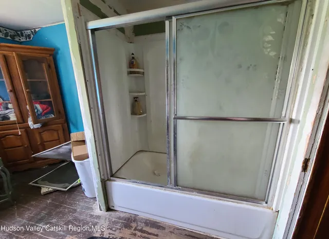 a bathroom with a shower and a mirror