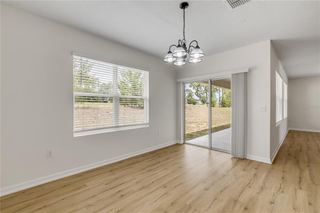 48 Hickory Loop Ocala, FL 34472 - Photo 10 of 52 a view of an empty room with wooden floor and a window