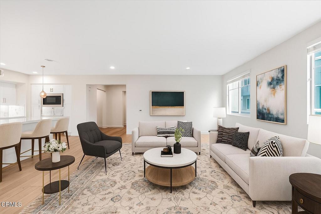 2830 Wagon Wheel Road, Unit 304 Oxnard, CA 93036 - Photo 11 of 44 a living room with furniture and a wooden floor