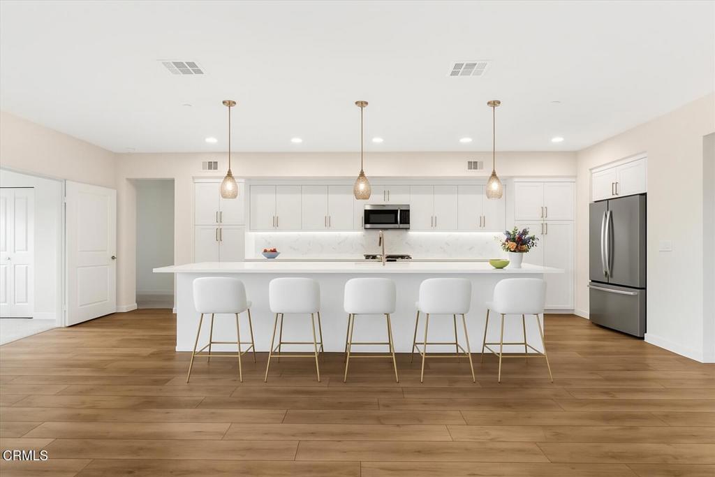 2830 Wagon Wheel Road, Unit 304 Oxnard, CA 93036 - Photo 2 of 44 a large kitchen with a table chairs refrigerator and cabinets