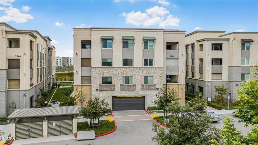 2830 Wagon Wheel Road, Unit 304 Oxnard, CA 93036 - Photo 39 of 44 a front view of a residential apartment building with a yard