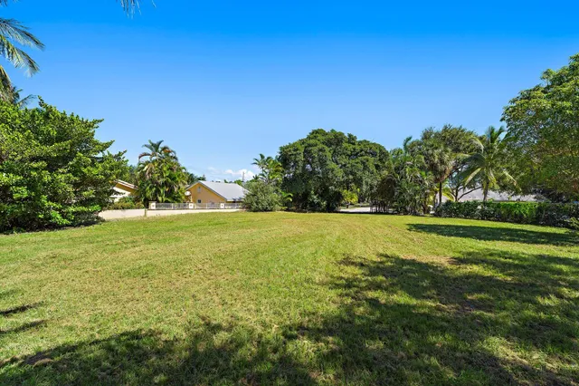 an aerial view of a house with a yard and garden