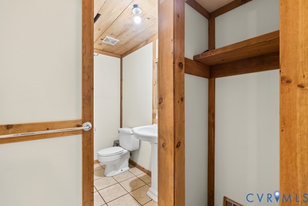 2371 Cedar Bend Road Appomattox, VA 24522 - Photo 41 of 50 a bathroom with a granite countertop sink mirror vanity and toilet