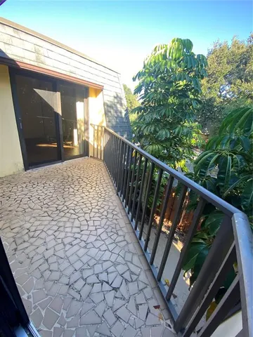 a view of balcony with wooden floor