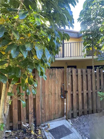 a view of wooden house with a tree