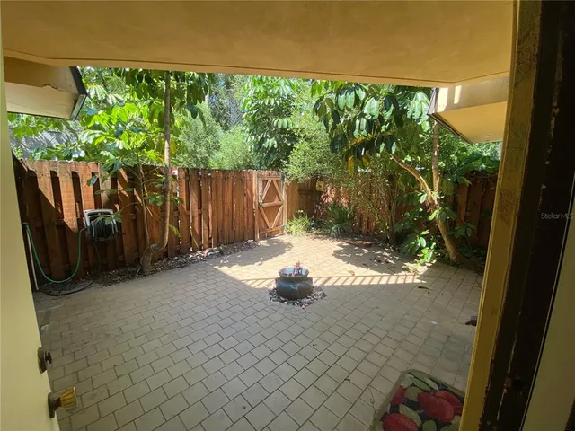 a view of a back yard of the house and trees