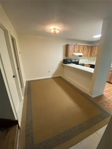 a view of kitchen and hall with wooden floor