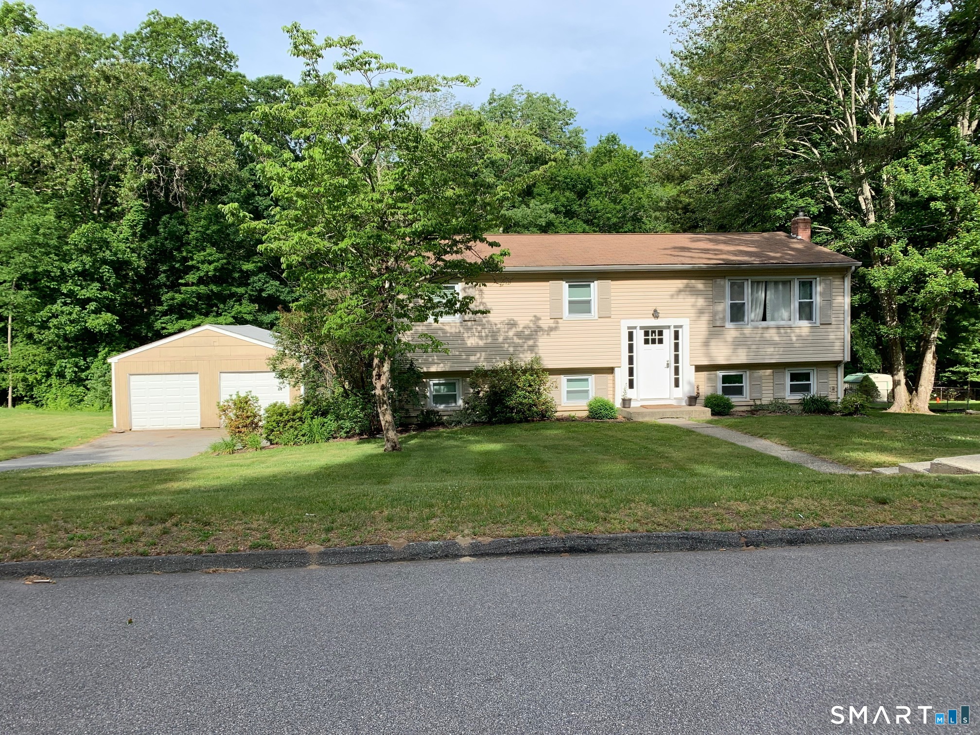 20 Willow Lane Ledyard, CT 06339 - Photo 2 of 21 a front view of a house with a garden and trees