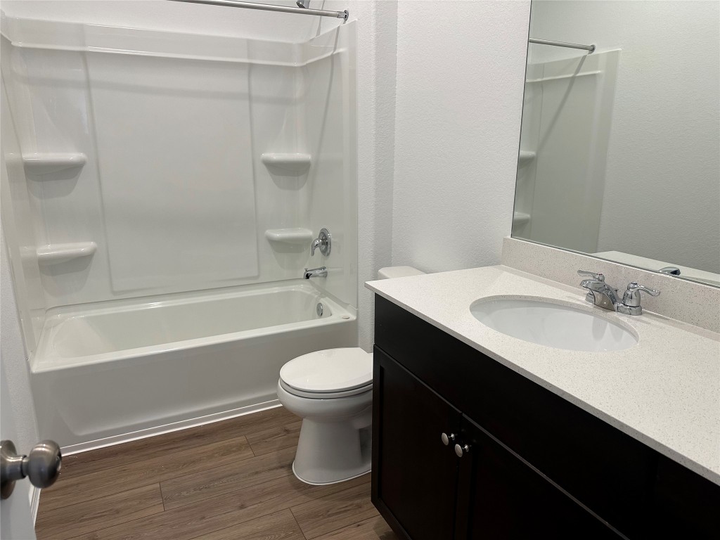 345 The Bad Way Jarrell, TX 76537 - Photo 10 of 34 a bathroom with a sink toilet a mirror and shower