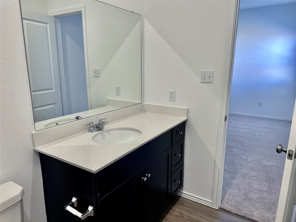 345 The Bad Way Jarrell, TX 76537 - Photo 11 of 34 a bathroom with a sink and a mirror