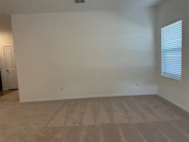 a view of living room with flat screen tv and kitchen view