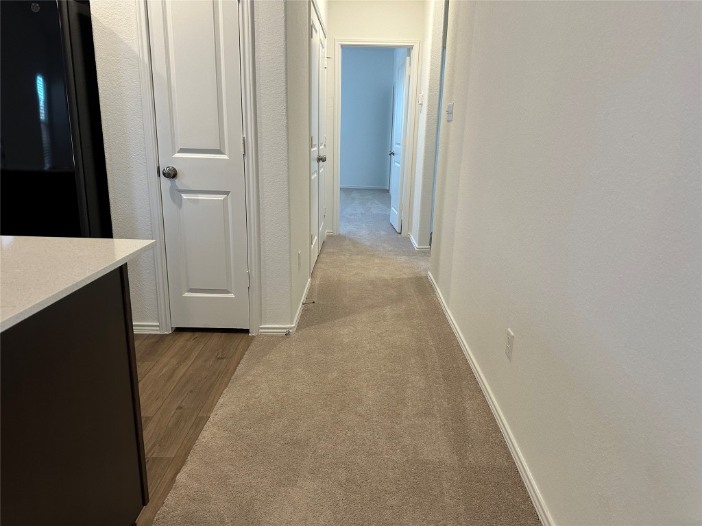 345 The Bad Way Jarrell, TX 76537 - Photo 6 of 34 a view of a hallway with wooden floor