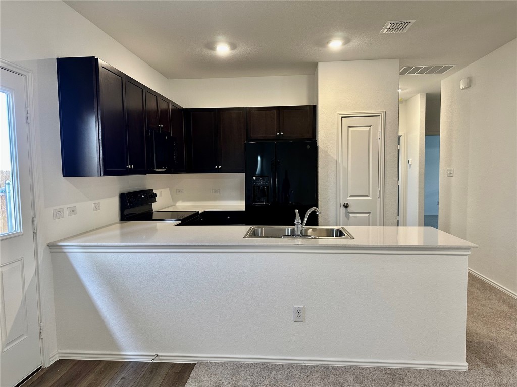 345 The Bad Way Jarrell, TX 76537 - Photo 7 of 34 a kitchen with kitchen island sink and refrigerator