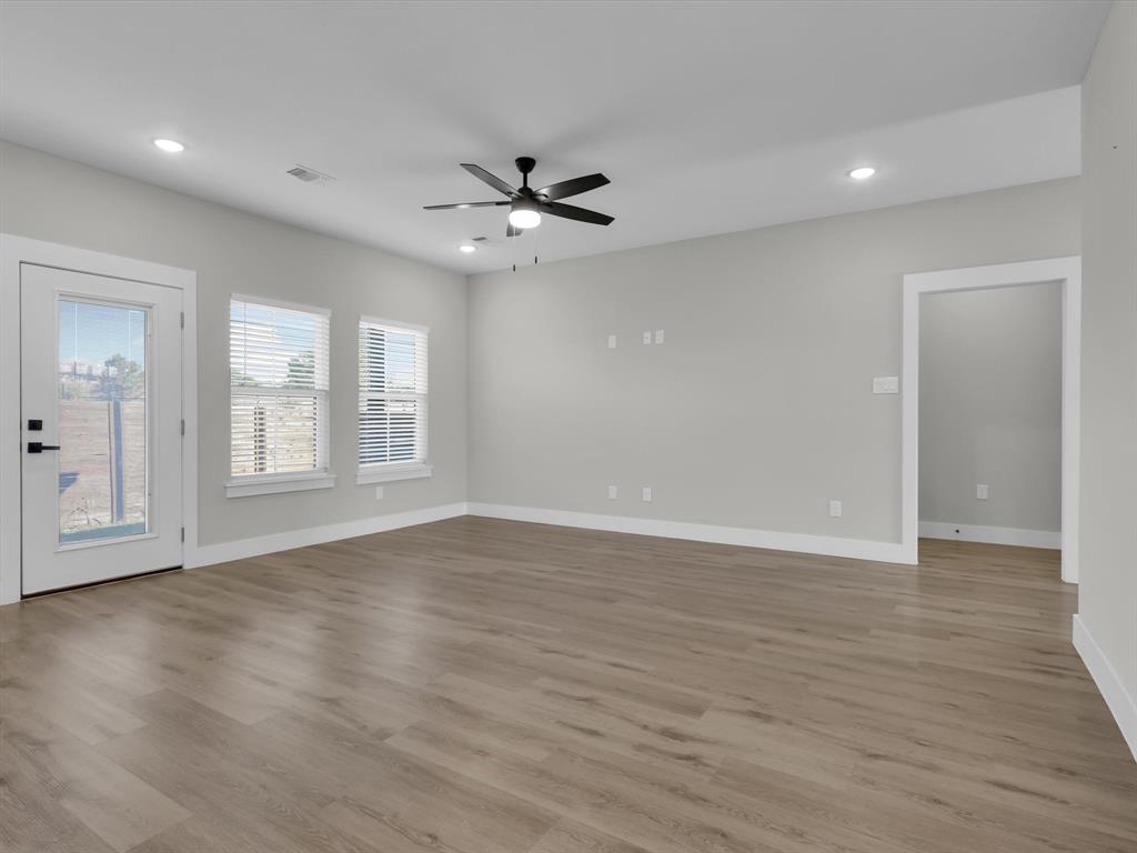 4905 Sweetbay Road Sherman, TX 75092 - Photo 11 of 26 a view of an empty room with a window and wooden floor