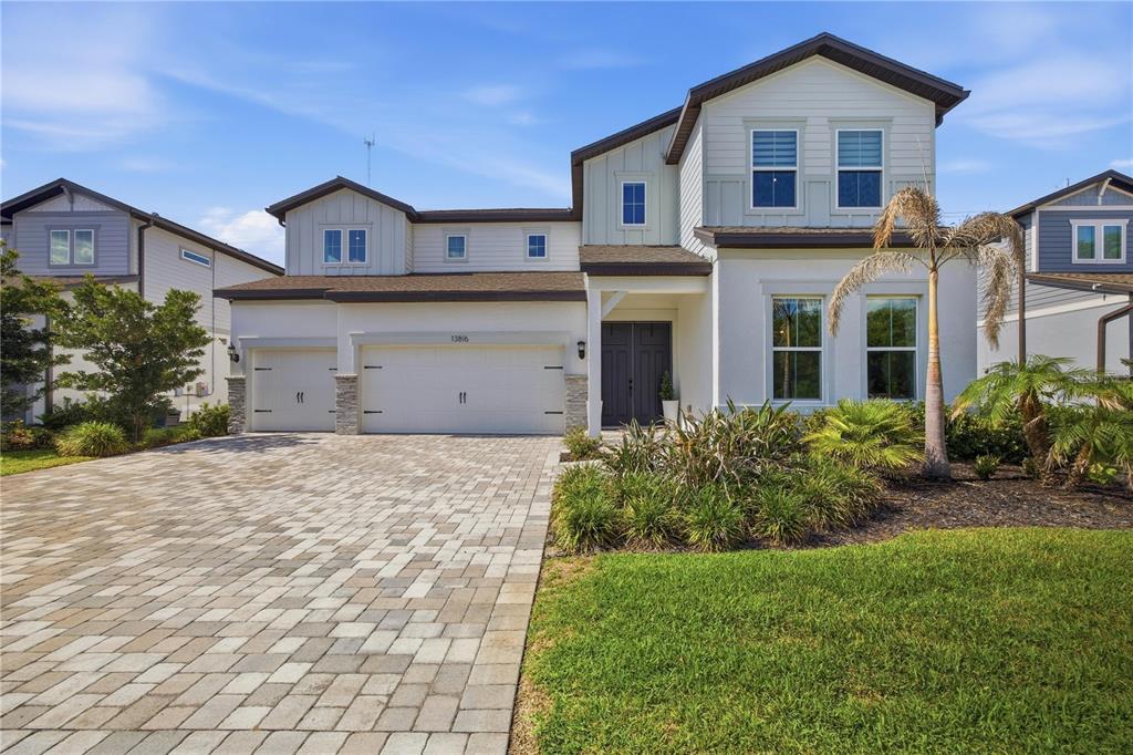 13816 Sharp Hawk Drive Riverview, FL 33569 - Photo 3 of 76 a view of a white house with a yard and plants