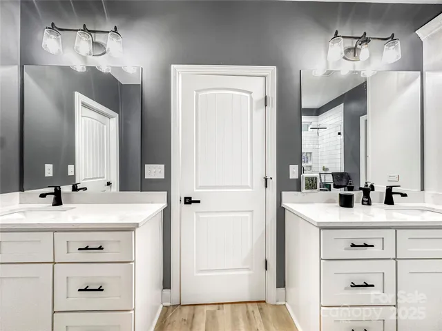 a bathroom with a sink vanity and a mirror