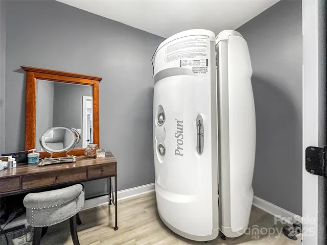 a living room with furniture and a mirror