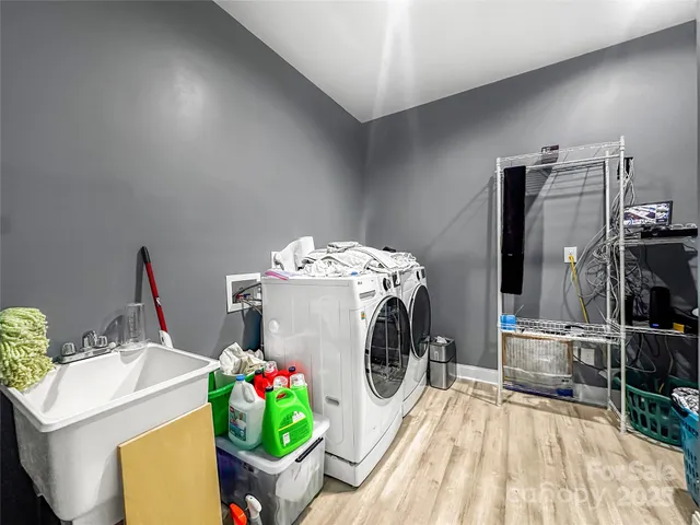 a dining room with furniture a chandelier and kitchen view