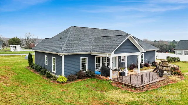 a front view of house with yard barbeque and outdoor seating