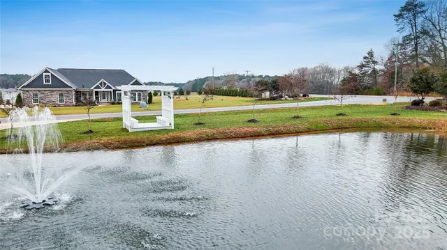 a view of swimming pool with a yard and sitting area