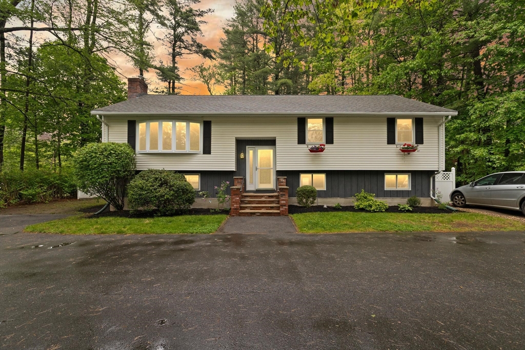 901 Haverhill Street Rowley, MA 01969 - Photo 1 of 42 a front view of a house with a yard and trees