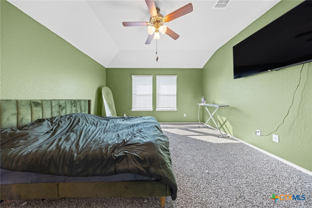 7203 Gilbert Drive Killeen, TX 76549 - Photo 9 of 16 a bedroom with a bed and a flat tv screen on dresser