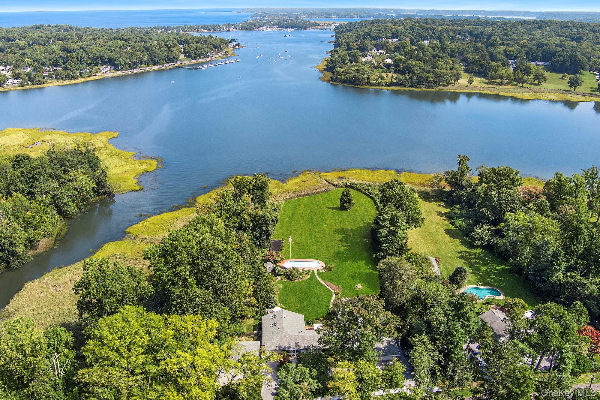 an aerial view of a houses with a lake view