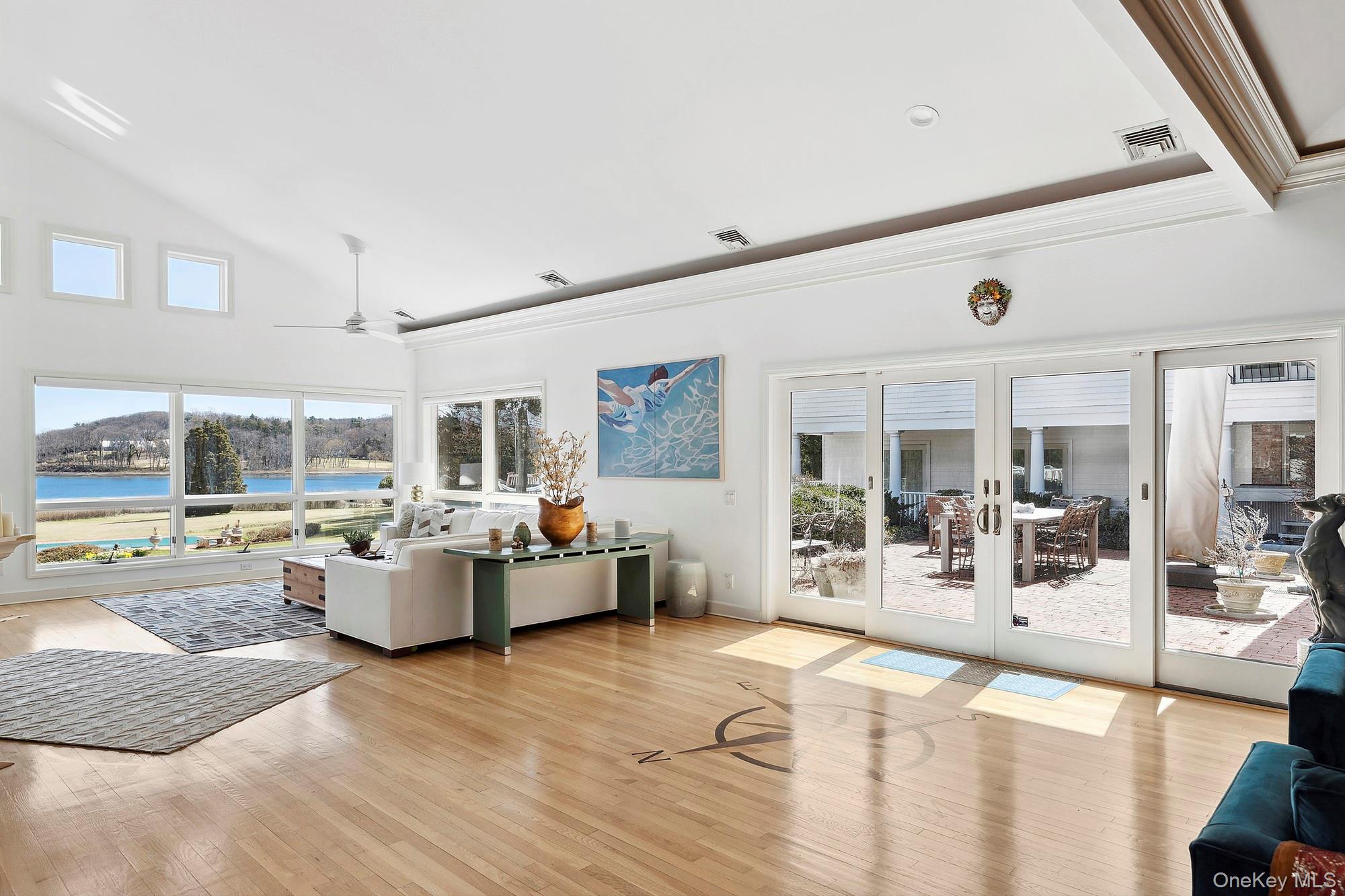 61 Factory Pond Road Locust Valley, NY 11560 - Photo 11 of 35 a living room with furniture large window and kitchen view