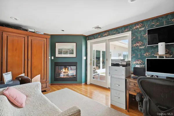 a bedroom with furniture and a flat screen tv