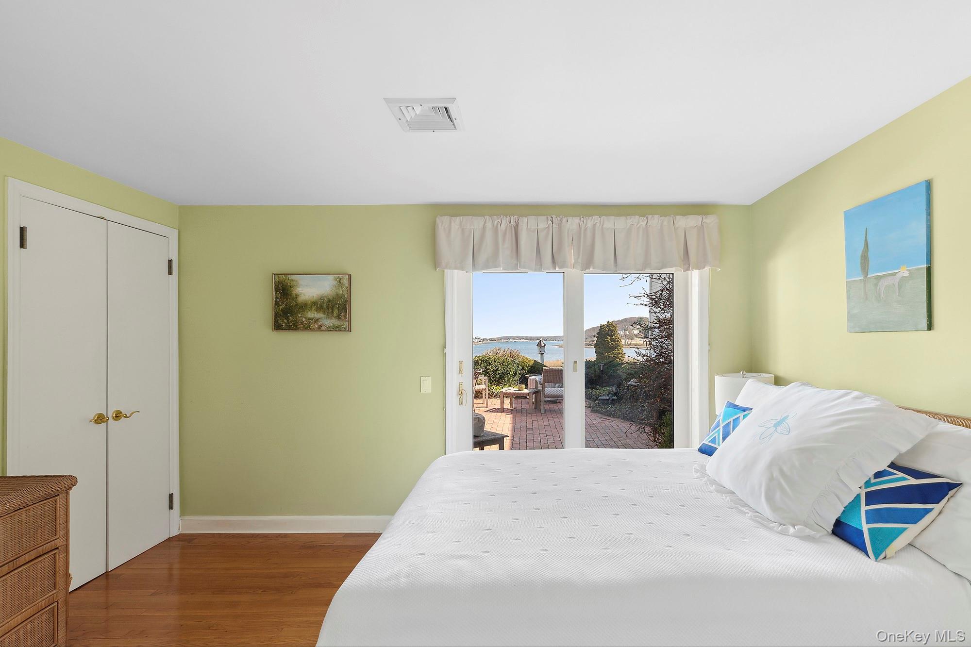 61 Factory Pond Road Locust Valley, NY 11560 - Photo 17 of 35 a bedroom with a bed and wooden floor