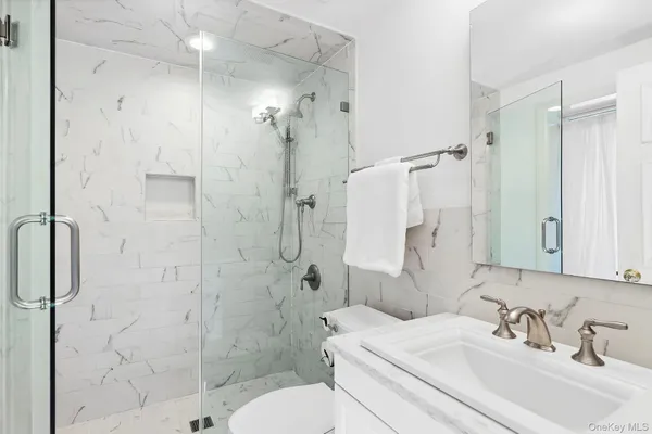 a bathroom with a sink toilet and shower