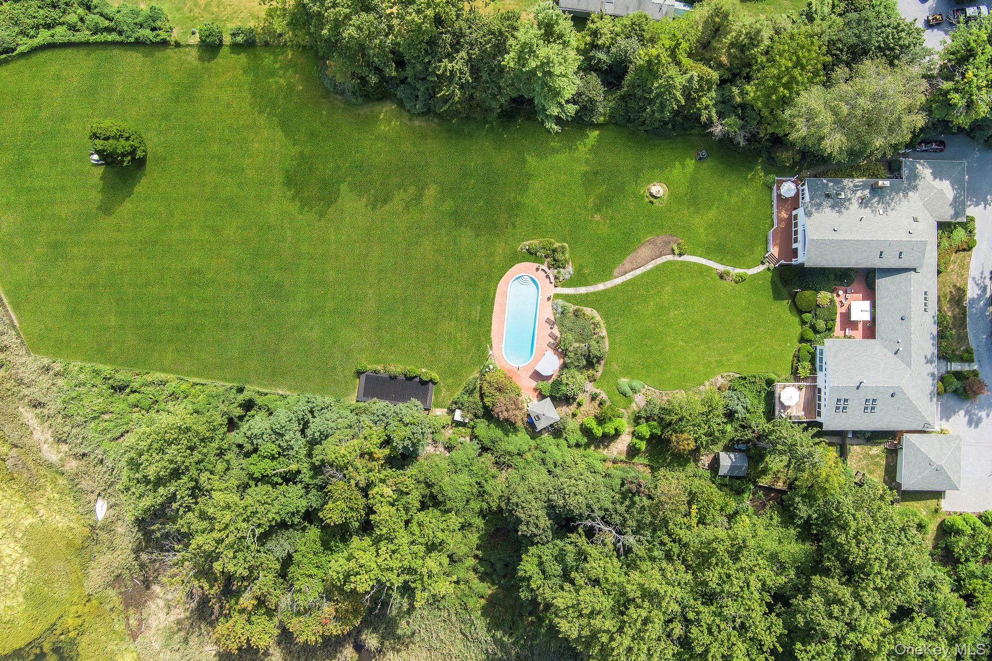 61 Factory Pond Road Locust Valley, NY 11560 - Photo 2 of 35 an aerial view of a house with a garden lake view and lake view