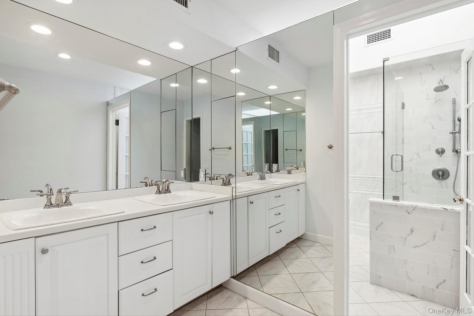 61 Factory Pond Road Locust Valley, NY 11560 - Photo 24 of 35 a spacious bathroom with a double vanity sink mirror and double