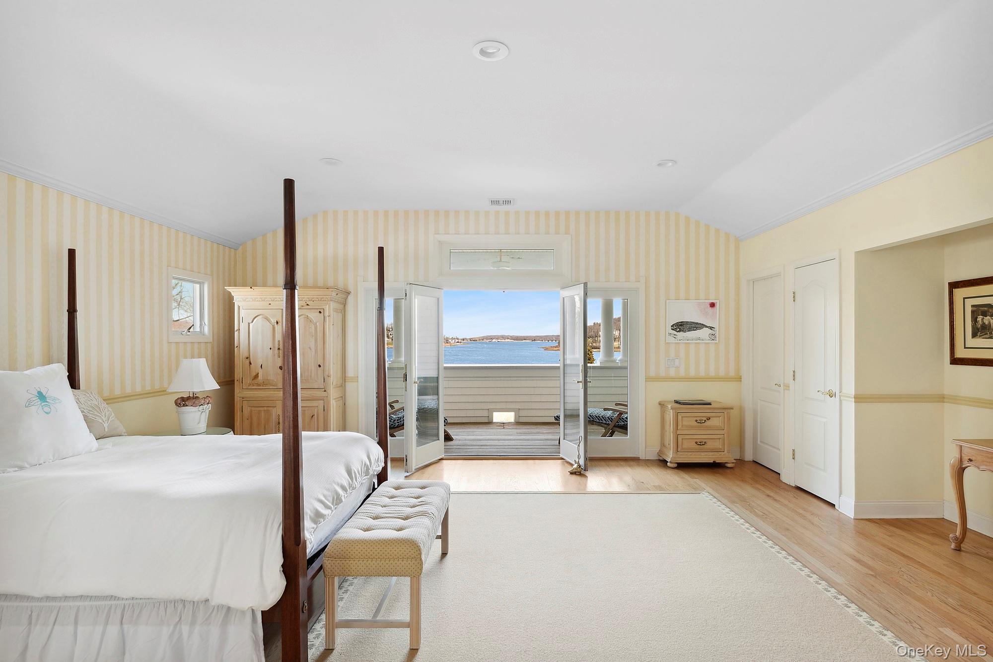 61 Factory Pond Road Locust Valley, NY 11560 - Photo 26 of 35 a large bedroom with a large bed and glass door