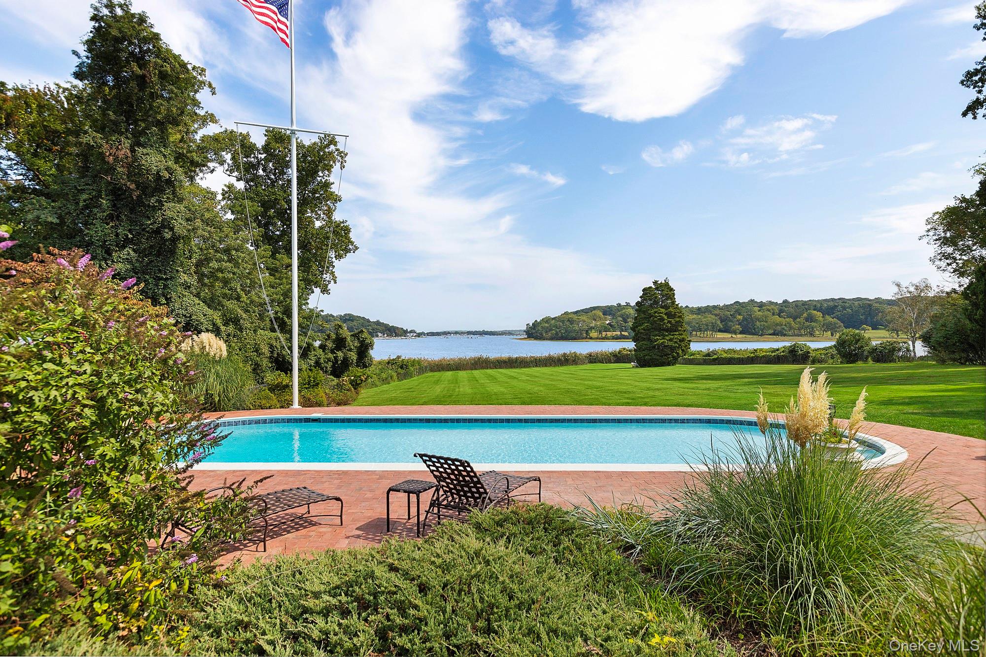 61 Factory Pond Road Locust Valley, NY 11560 - Photo 31 of 35 a view of a swimming pool with a yard and plants