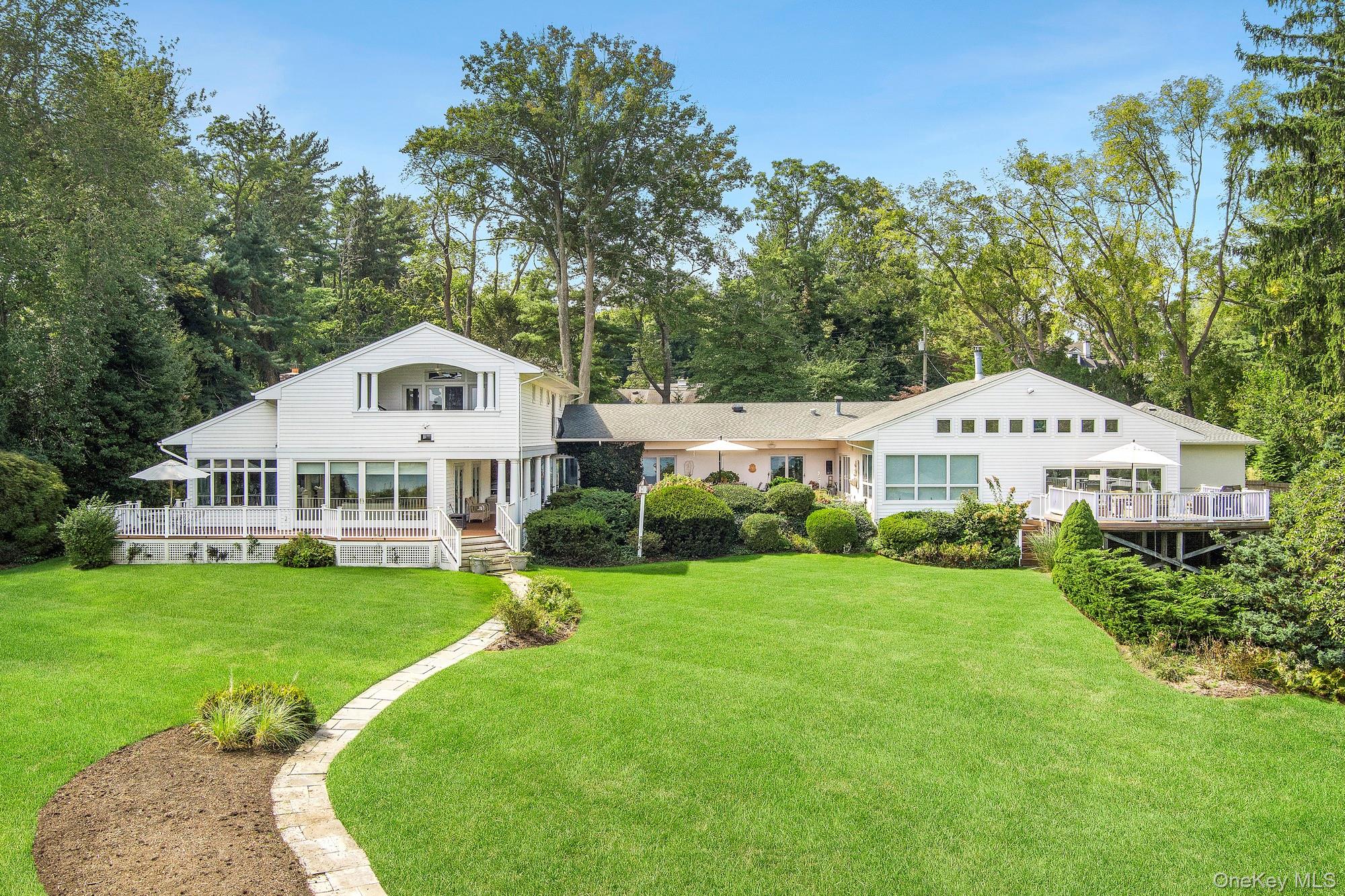 61 Factory Pond Road Locust Valley, NY 11560 - Photo 35 of 35 a white house with a big yard and large trees