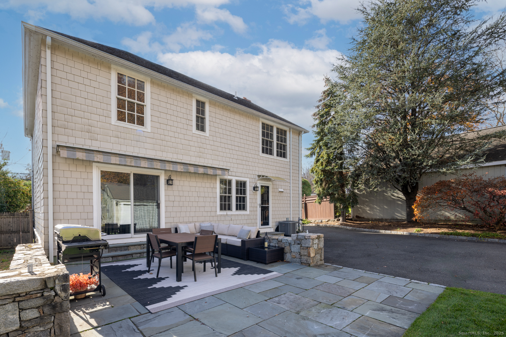 77 Maple Street Darien, CT 06820 - Photo 18 of 23 a backyard of a house with outdoor seating