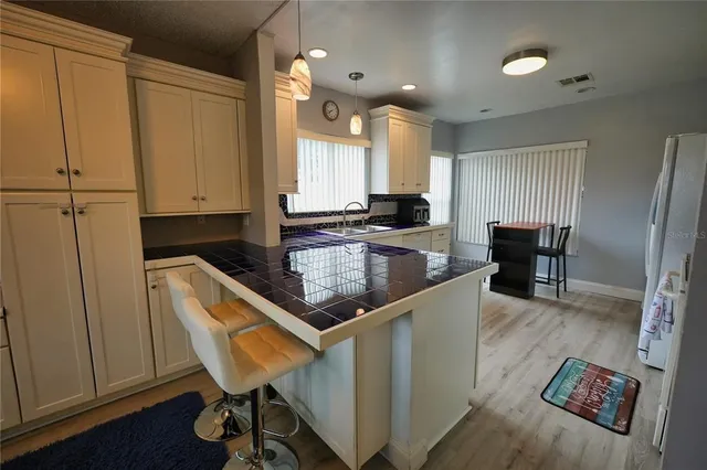 a kitchen with stainless steel appliances granite countertop sink refrigerator and microwave