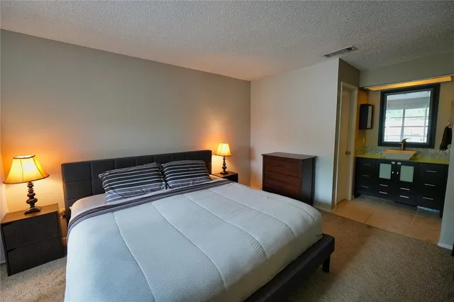 a bedroom with a bed and a view of bedroom