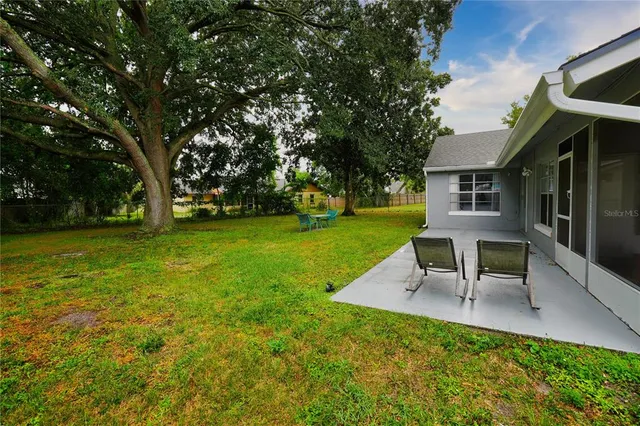 a view of a house with a yard porch and sitting area