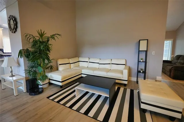 a bedroom with furniture and a potted plant