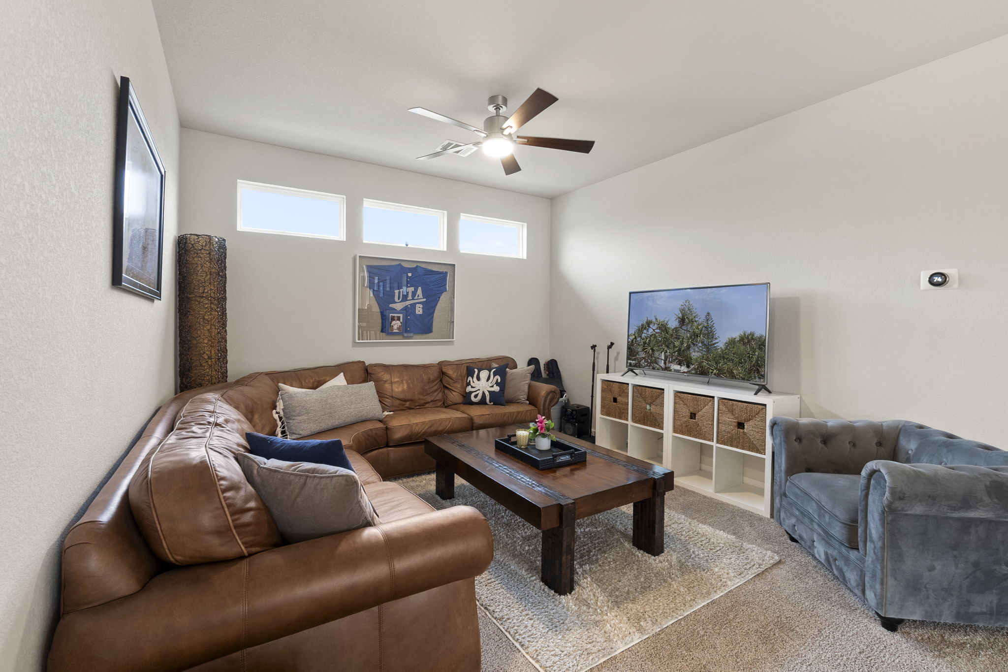 460 Constitution Way Kyle, TX 78640 - Photo 23 of 40 Spacious living area featuring a vaulted ceiling, ceiling fan with light fixture, and high transom windows