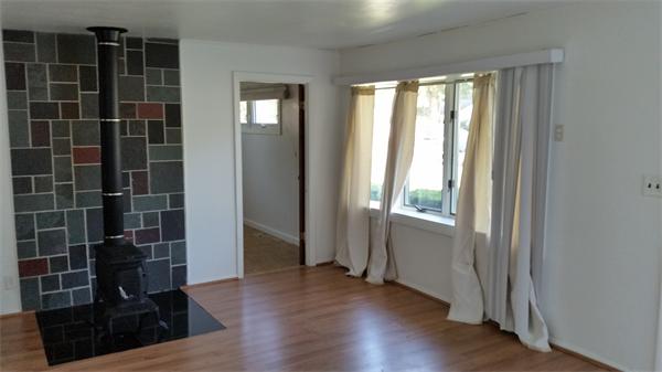 125 Groton Street Springfield, MA 01129 - Photo 5 of 10 an empty room with wooden floor and windows