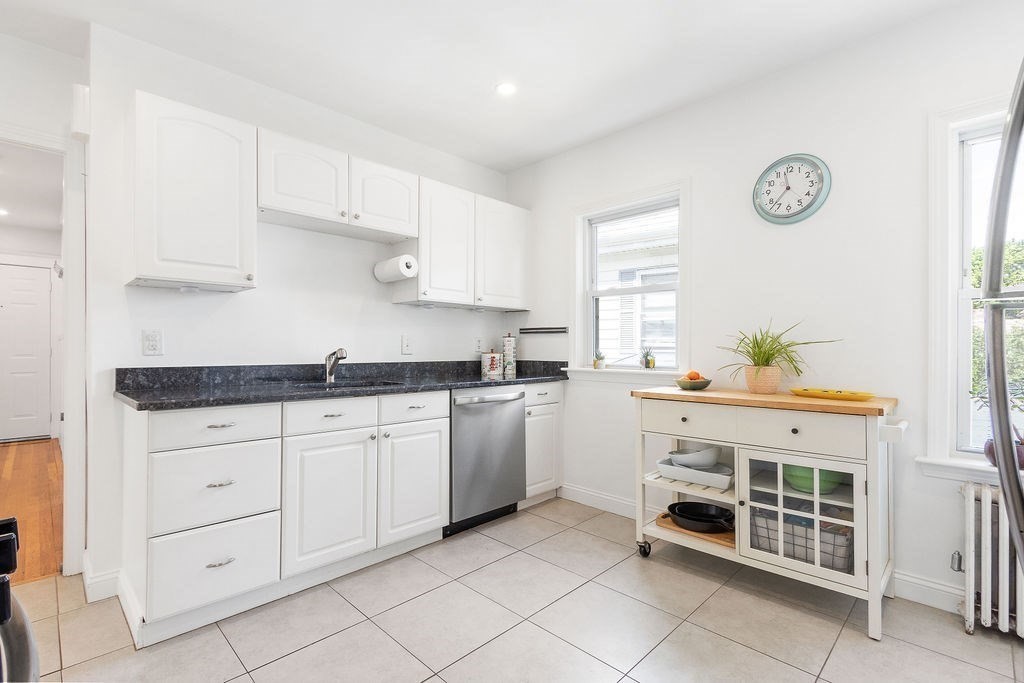 43 Sheffield Road, Unit 2 Boston, MA 02131 - Photo 2 of 16 a kitchen with granite countertop white cabinets and white appliances